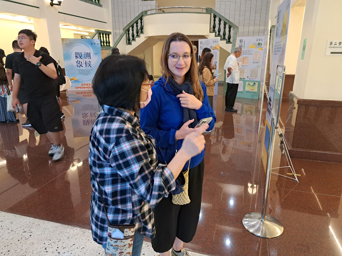 圖二：檔案館館員張慧貞於展場協助民眾線上填寫學習單，並解說展覽內容。